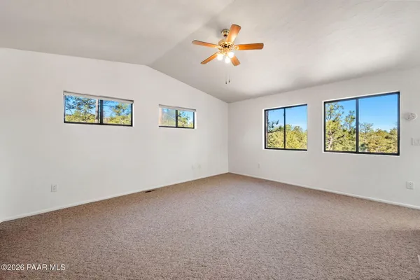 a view of an empty room with a painting on the wall