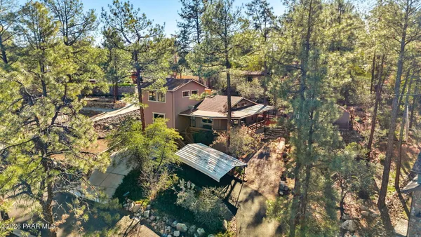 an aerial view of a house with a yard