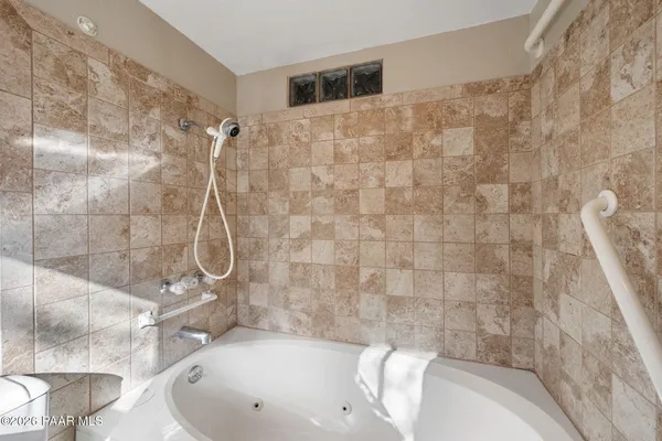 a bathroom with a bathtub and shower
