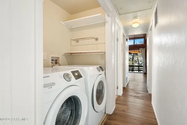 a view of a hallway with washer and dryer