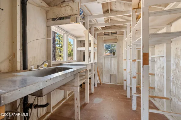a hall with a sink and a large mirror