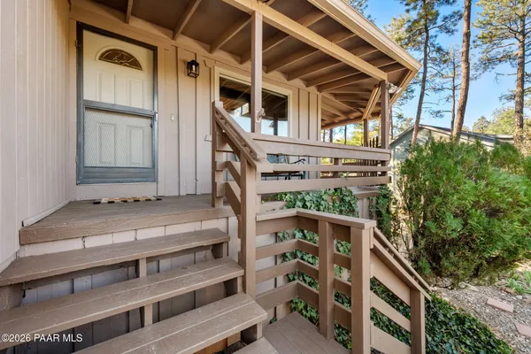 a view of house with wooden fence and windows