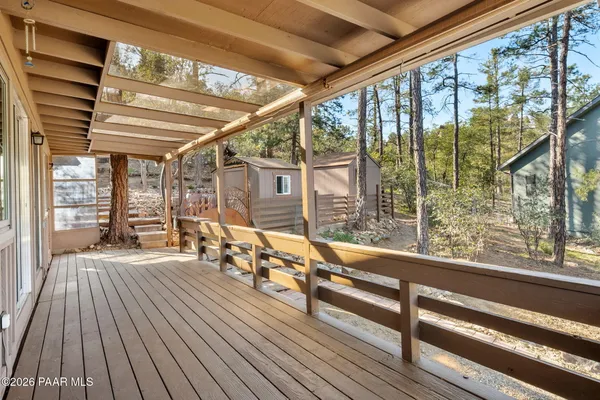 a view of a room with wooden floor and iron stairs