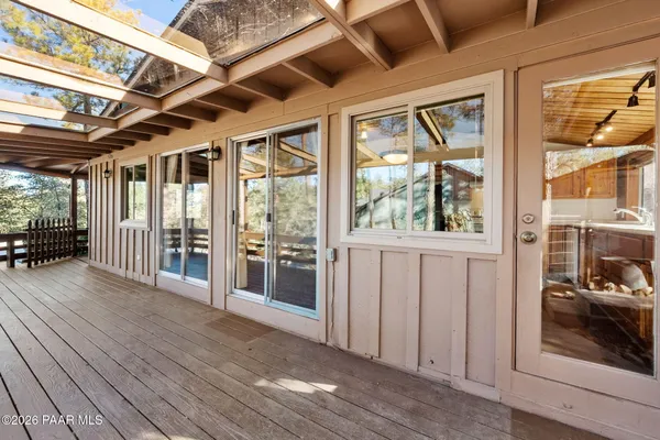 a view of a porch with wooden floor and windows