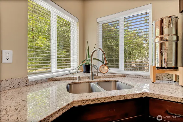 a kitchen with granite countertop a sink and a window