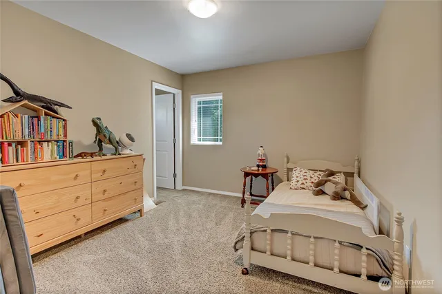 a bedroom with a bed and a dresser