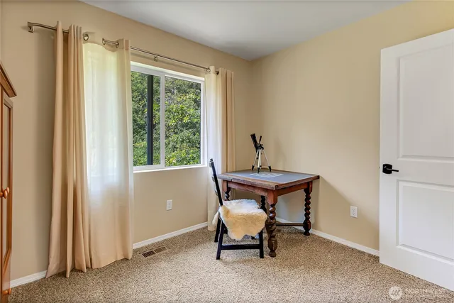 a room that has a bench and a window