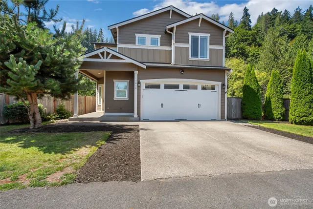a front view of a house with a yard and garage