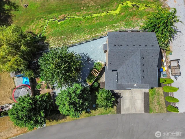 an aerial view of a house with garden space and street view