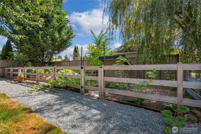 a view of a garden with wooden fence