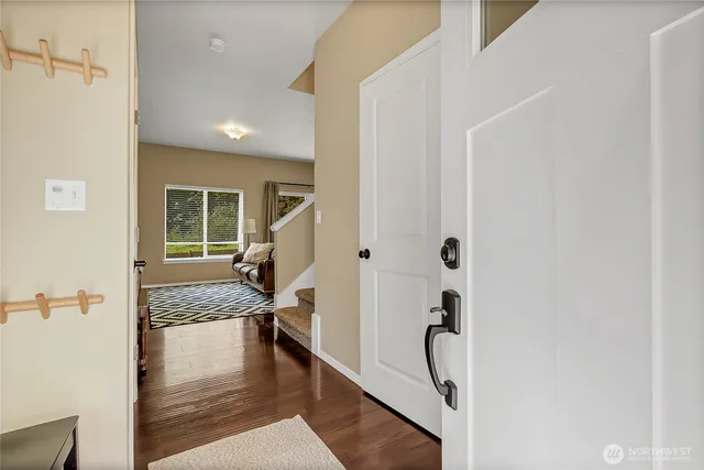 a view of entryway and hall with wooden floor