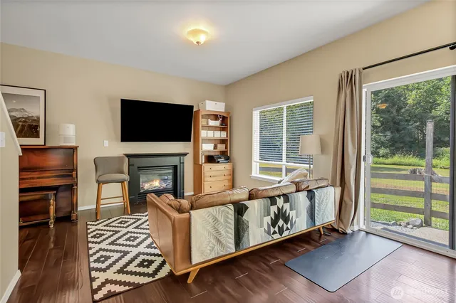 a living room with fireplace furniture and a flat screen tv