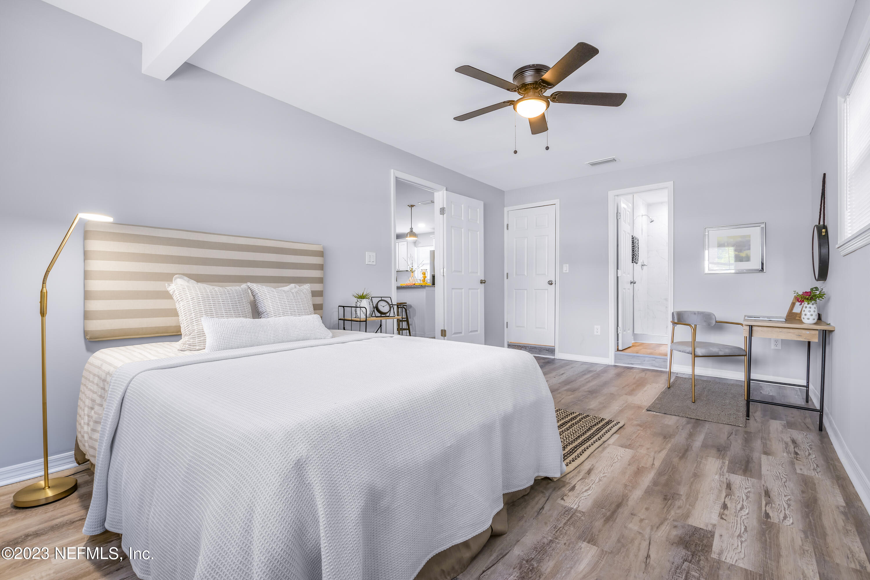 295 Edson Drive Orange Park, FL 32073 - Photo 16 of 37 a spacious bedroom with a bed and a chandelier