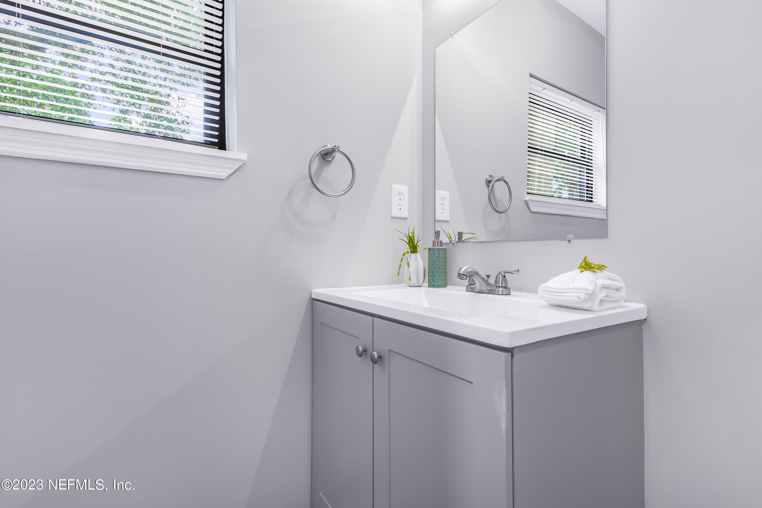 295 Edson Drive Orange Park, FL 32073 - Photo 19 of 37 a bathroom with a sink and a mirror
