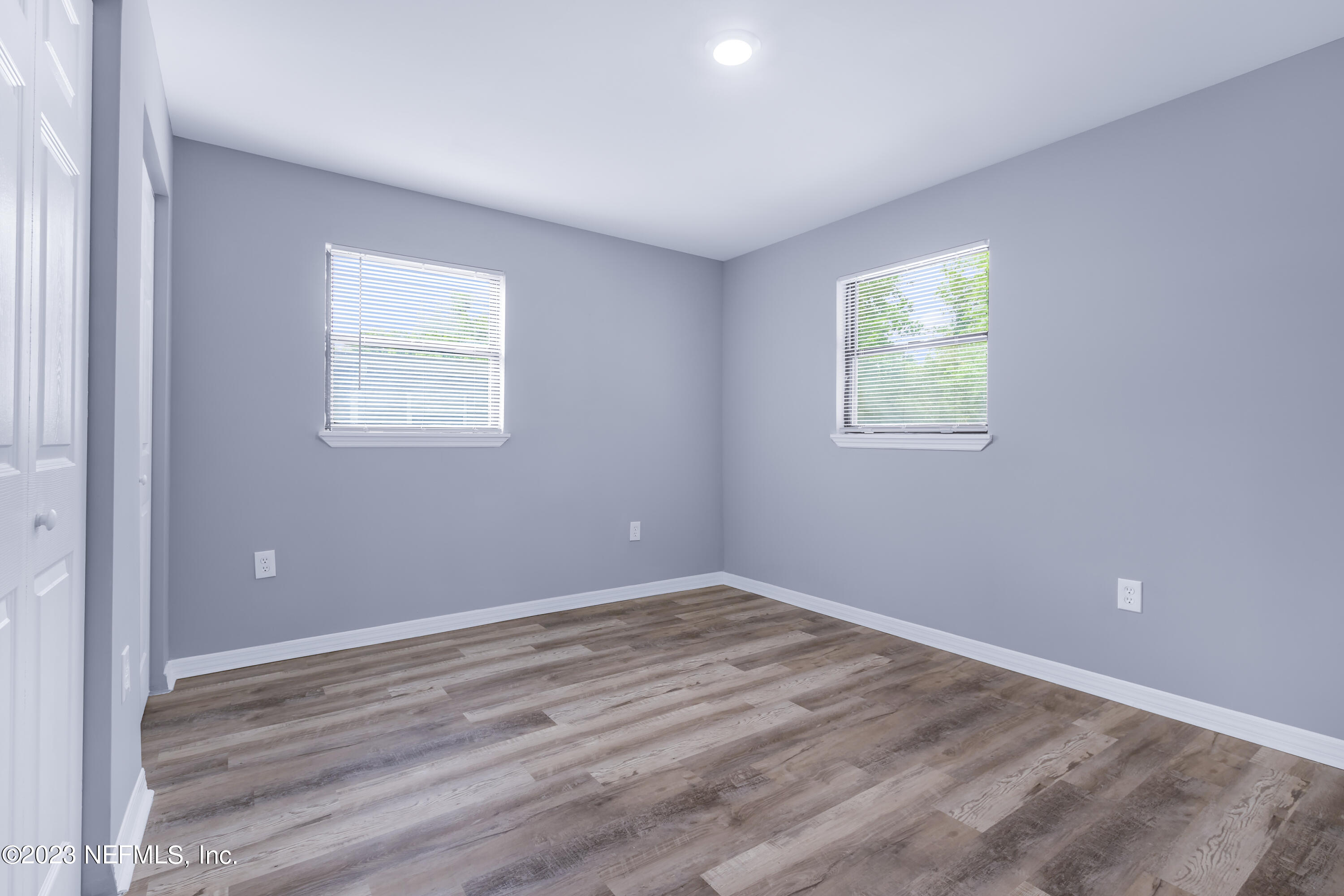 295 Edson Drive Orange Park, FL 32073 - Photo 21 of 37 a view of an empty room with wooden floor and a window