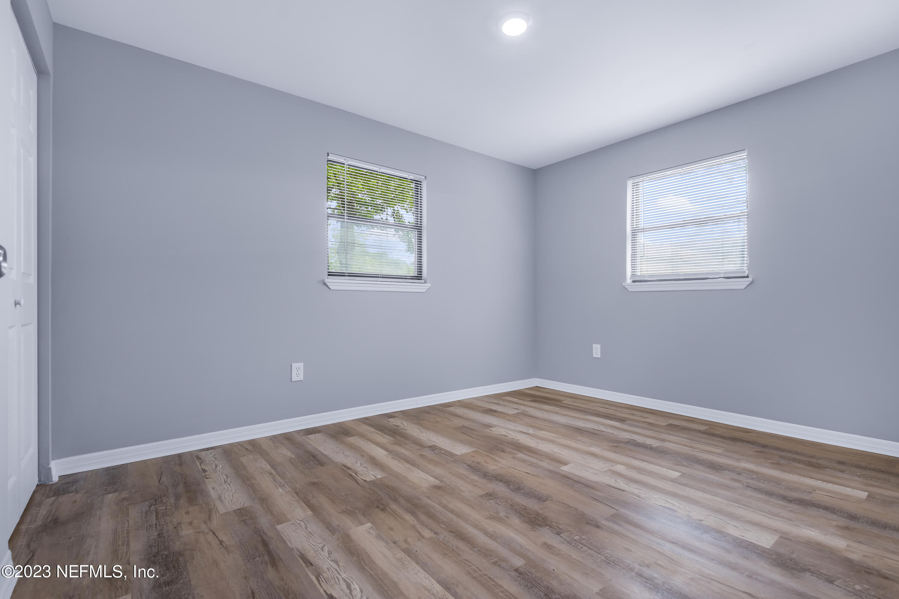 295 Edson Drive Orange Park, FL 32073 - Photo 24 of 37 a view of an empty room with wooden floor and a window