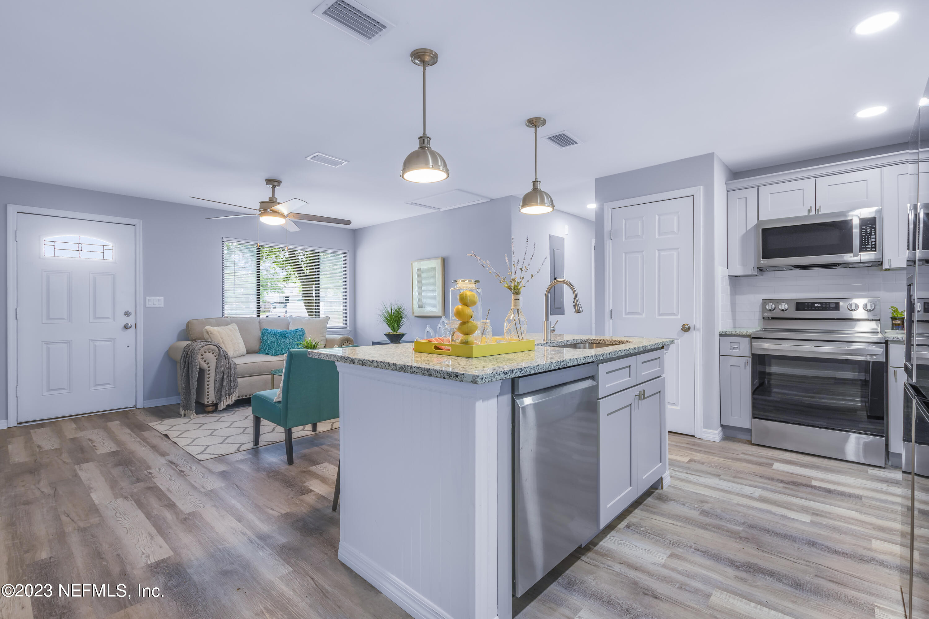 295 Edson Drive Orange Park, FL 32073 - Photo 28 of 37 a kitchen with sink cabinets and wooden floor