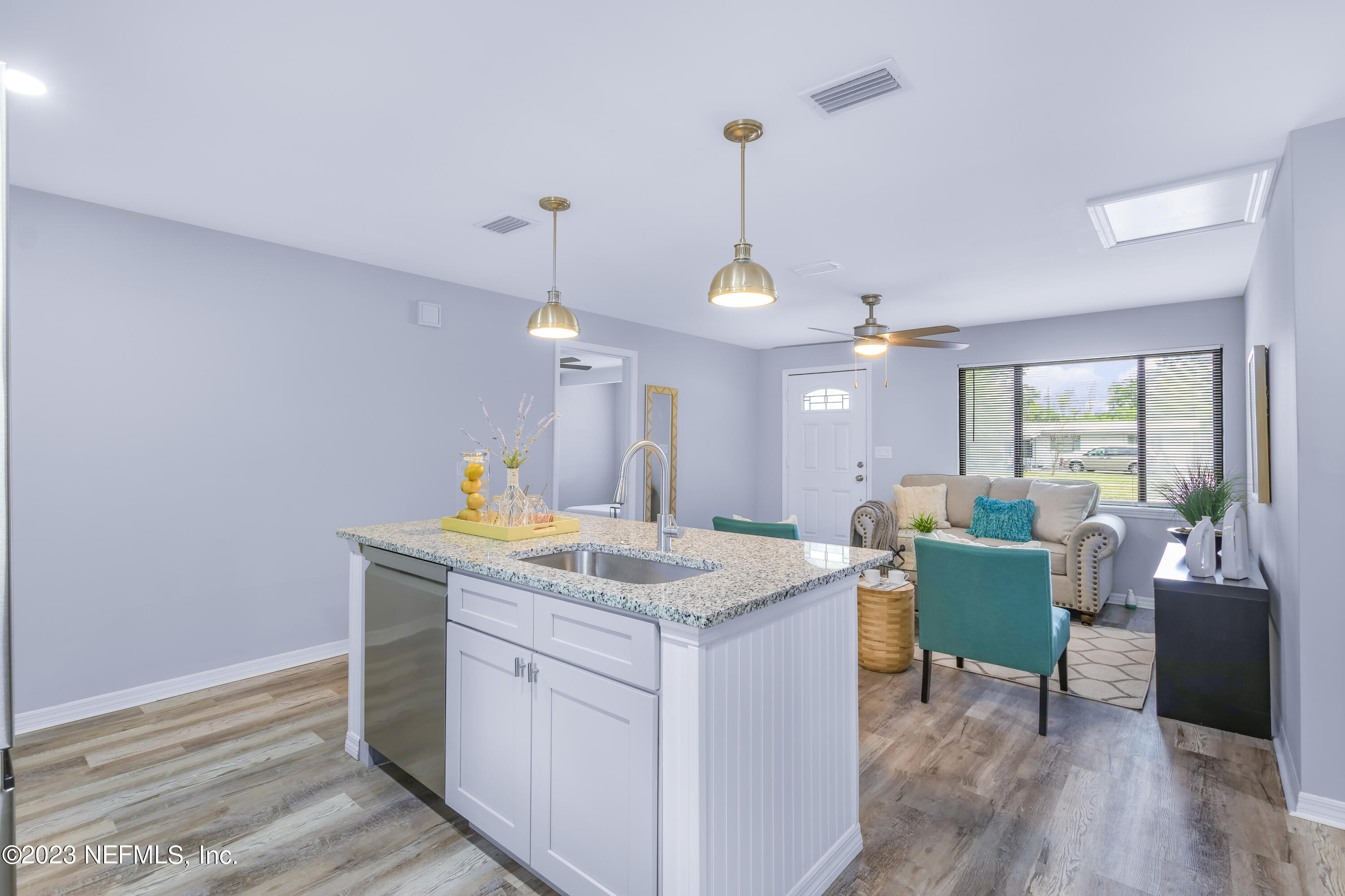 295 Edson Drive Orange Park, FL 32073 - Photo 30 of 37 a kitchen with a table chairs and wooden floor