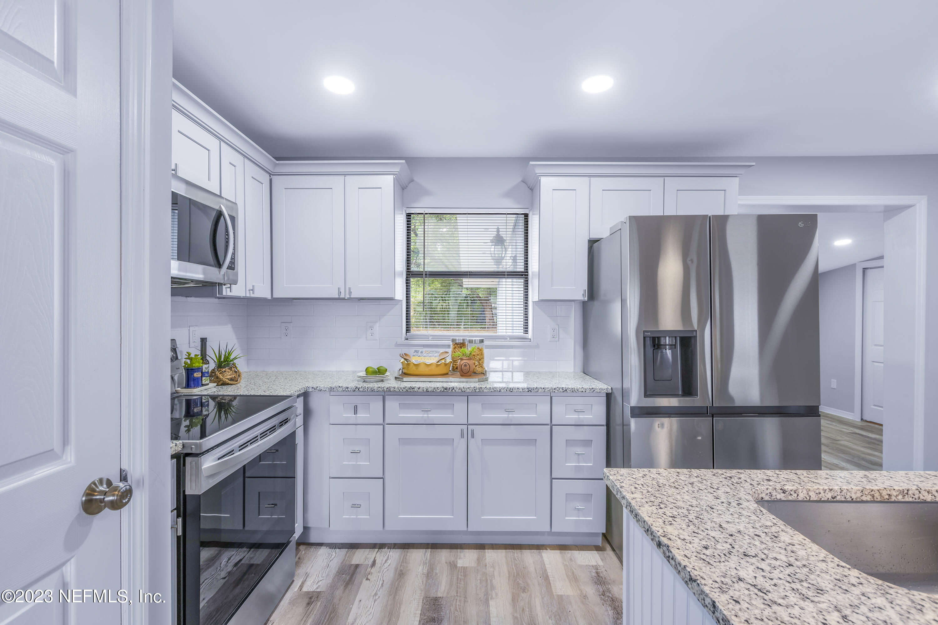 295 Edson Drive Orange Park, FL 32073 - Photo 6 of 37 a kitchen with granite countertop a refrigerator and a sink