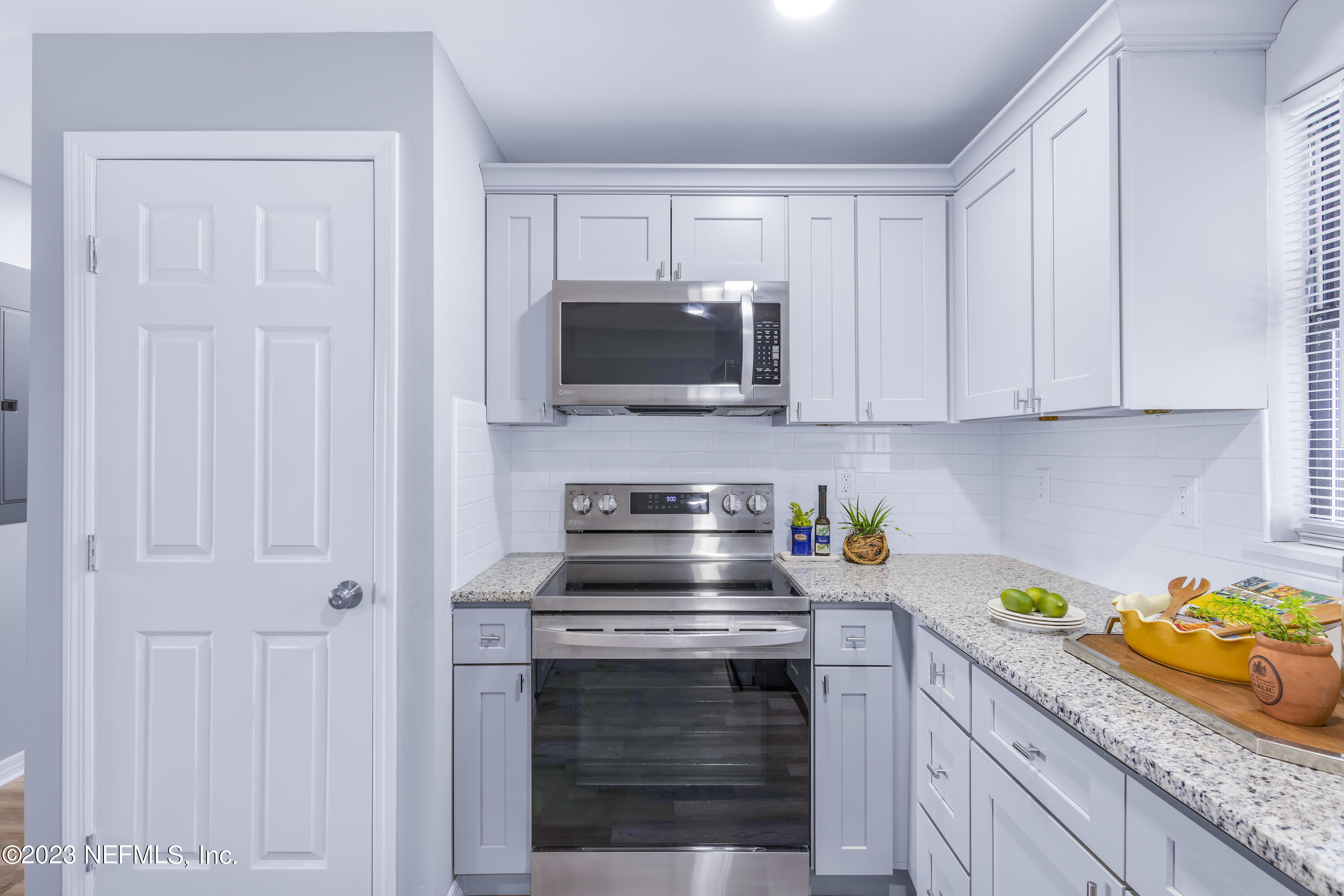 295 Edson Drive Orange Park, FL 32073 - Photo 8 of 37 a kitchen with a stove and a microwave