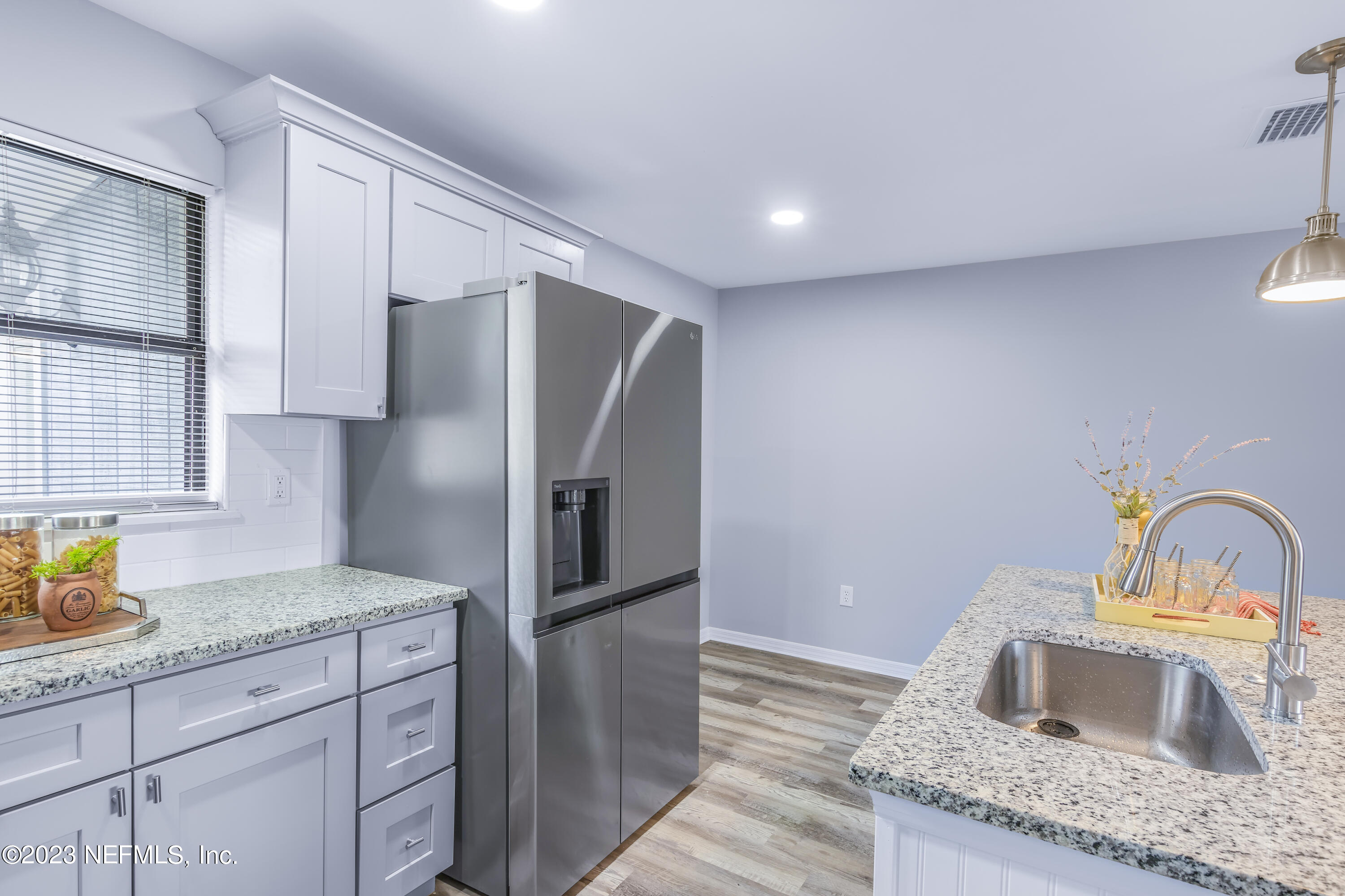 295 Edson Drive Orange Park, FL 32073 - Photo 9 of 37 a kitchen with granite countertop a sink stainless steel appliances and cabinets