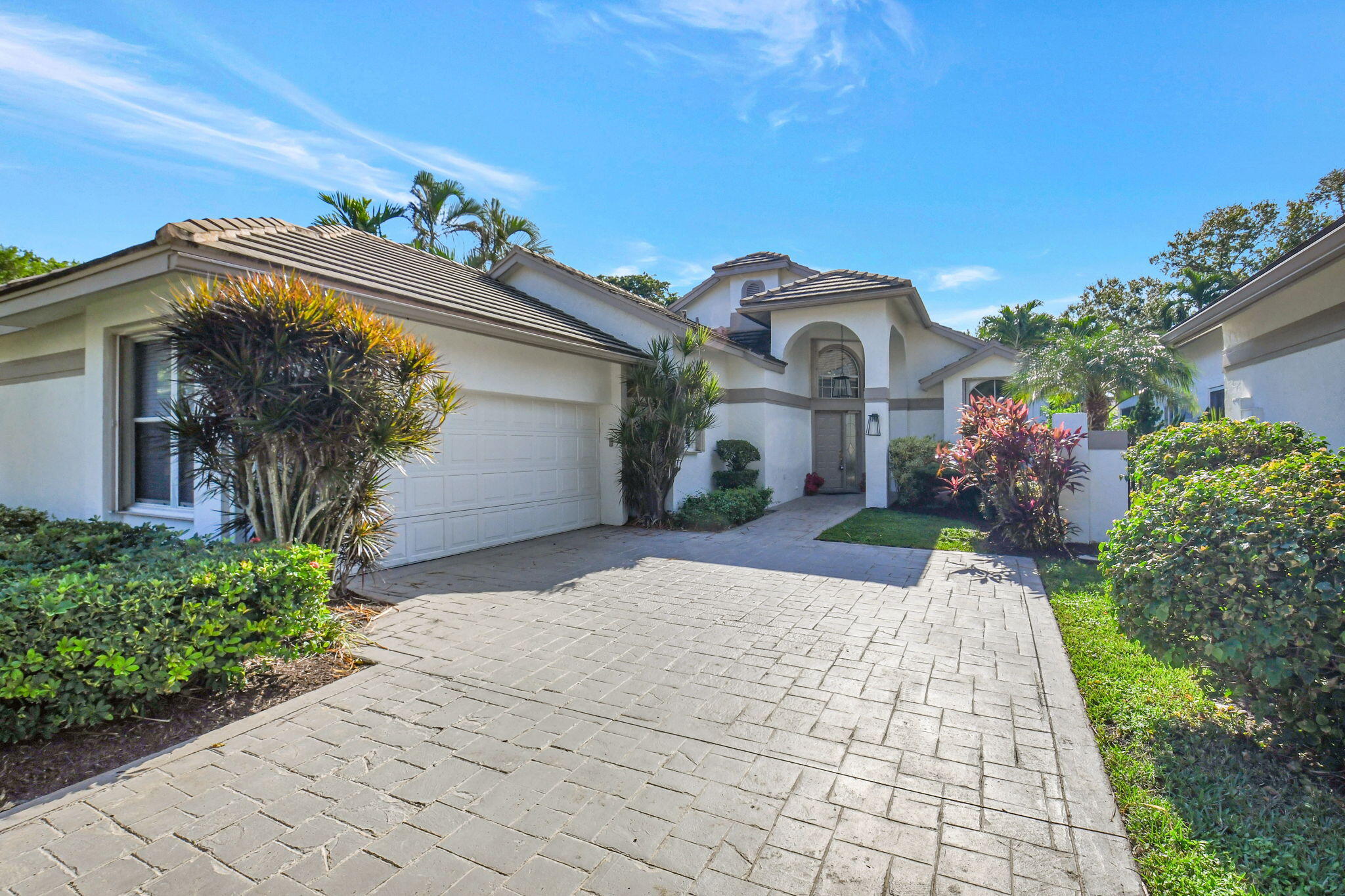 a front view of a house with a garden