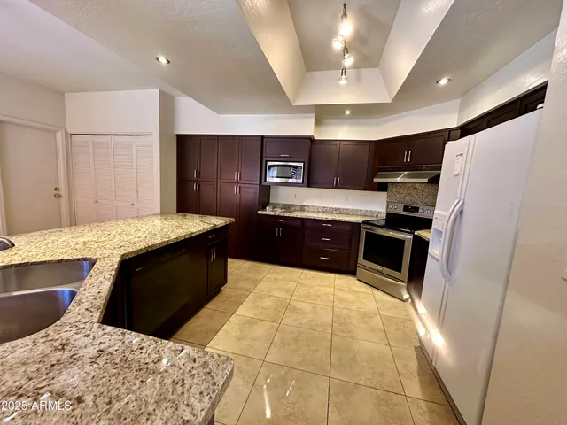 a view of kitchen with furniture and a ceiling fan