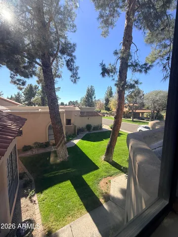 a backyard of a house with table and chairs