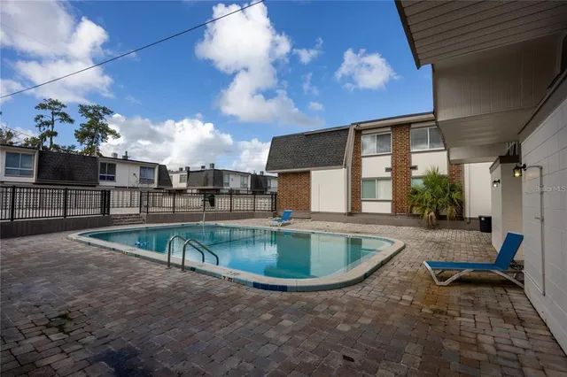 a view of a swimming pool with a patio