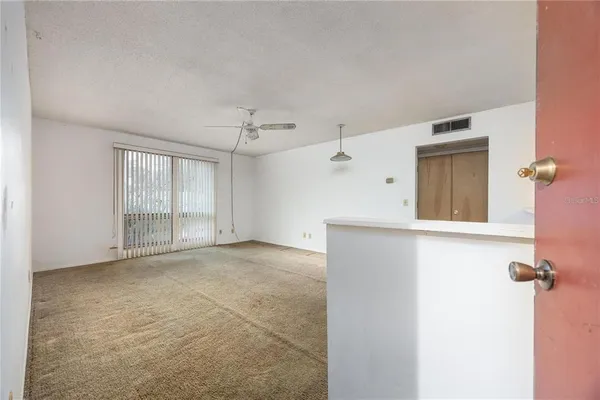 a view of a big room with windows and cabinet