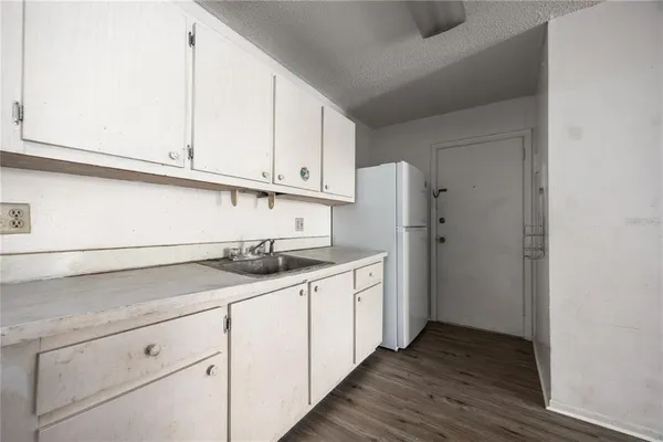 a kitchen with stainless steel appliances granite countertop a sink and a white cabinets