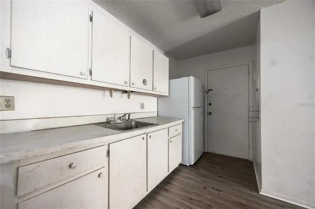 a kitchen with stainless steel appliances granite countertop a sink and a white cabinets