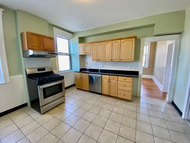 a kitchen with stainless steel appliances a stove a sink and a microwave