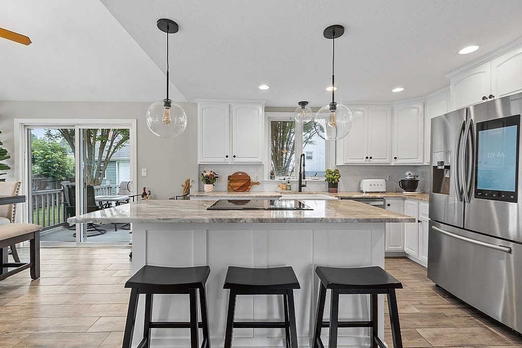 42 Ancona Road Worcester, MA 01604 - Photo 12 of 38 a kitchen with kitchen island granite countertop a sink a center island stainless steel appliances and cabinets