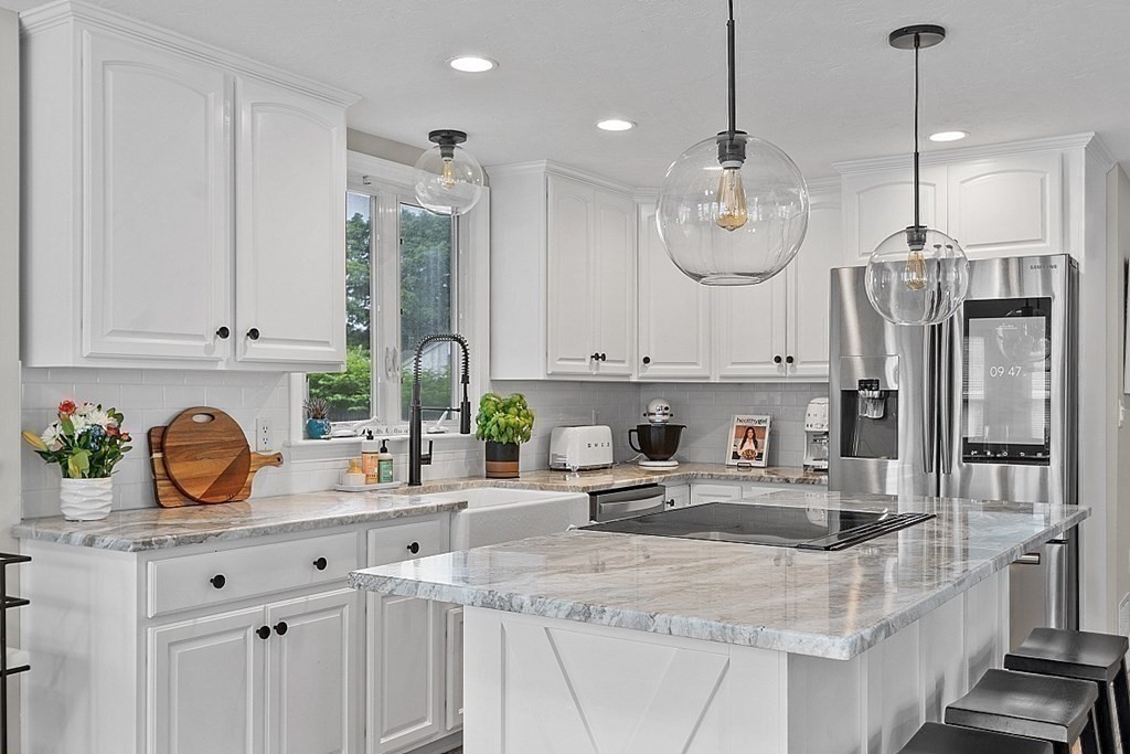 42 Ancona Road Worcester, MA 01604 - Photo 13 of 38 a kitchen with stainless steel appliances granite countertop a sink a stove and a white cabinets