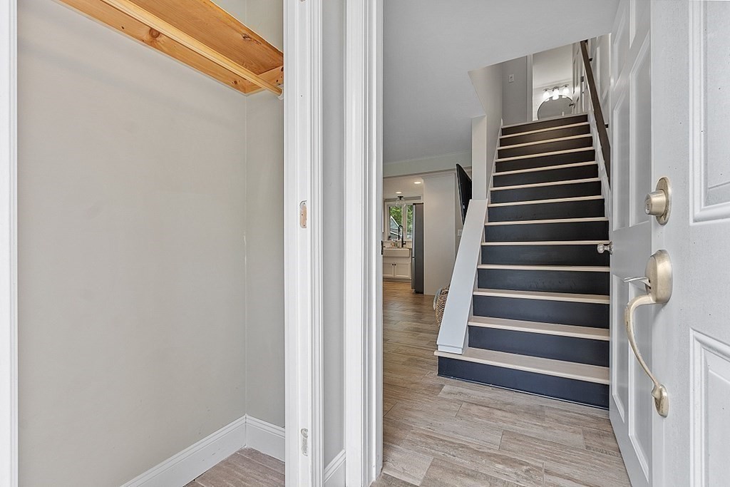 42 Ancona Road Worcester, MA 01604 - Photo 8 of 38 a view of a hallway with stairs and wooden floor