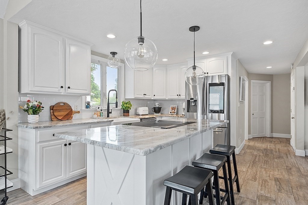 42 Ancona Road Worcester, MA 01604 - Photo 9 of 38 a kitchen with kitchen island granite countertop a sink cabinets and refrigerator