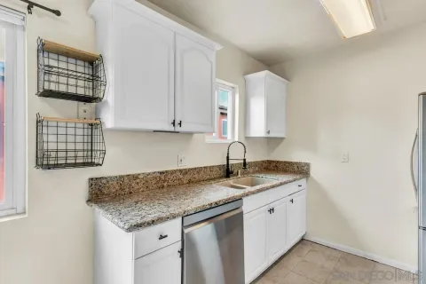 a kitchen with stainless steel appliances granite countertop a sink and cabinets