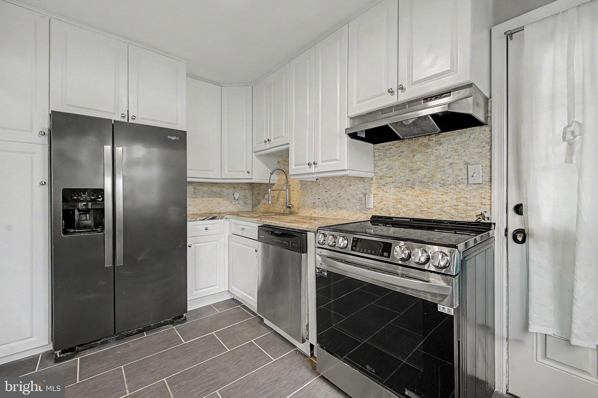 16 Malvern Road Newark, DE 19713 - Photo 8 of 35 a kitchen with refrigerator and cabinets