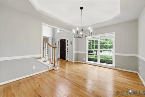 a view of an empty room with a cabinet and a window