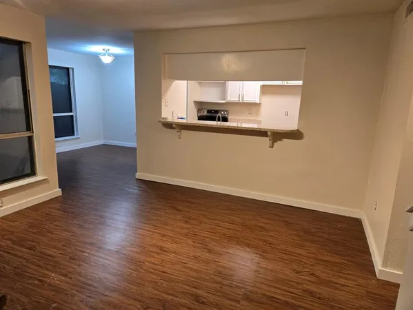 a view of a kitchen with a sink and a mirror