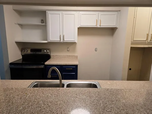 a kitchen with a sink and cabinets