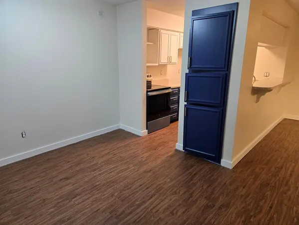 a view of kitchen with wooden floor and electronic appliances