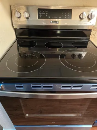 a stove top oven sitting inside of a kitchen