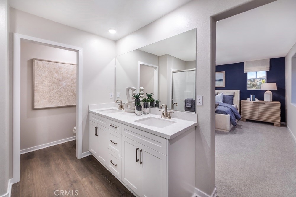 9573 Glenmore Frst Drive Riverside, CA 92508 - Photo 7 of 11 a spacious bathroom with a double vanity sink and mirror