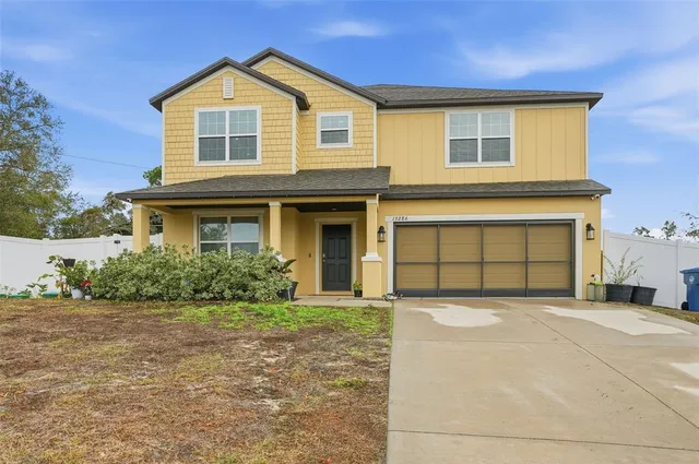 a front view of a house with a yard and garage