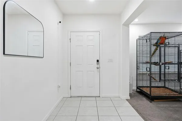 a living room with furniture a flat screen tv and a book shelf
