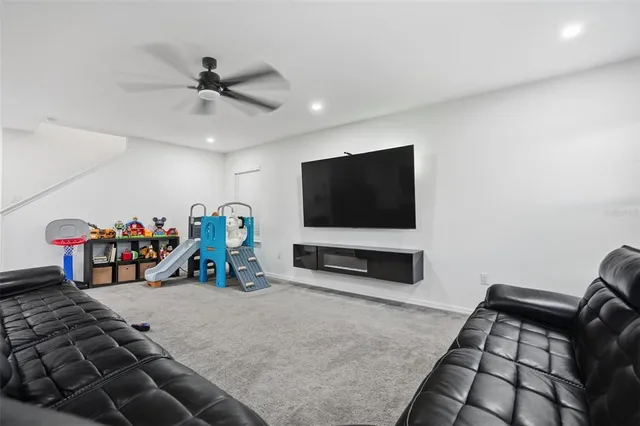 a view of a livingroom with workspace and a window