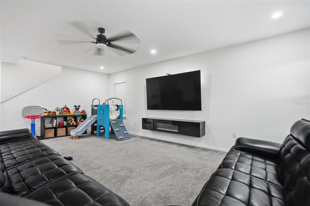 13286 Pendleton Street Spring Hill, FL 34609 - Photo 21 of 57 a view of a livingroom with furniture and a flat screen tv
