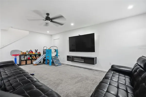 a view of a livingroom with workspace and a window